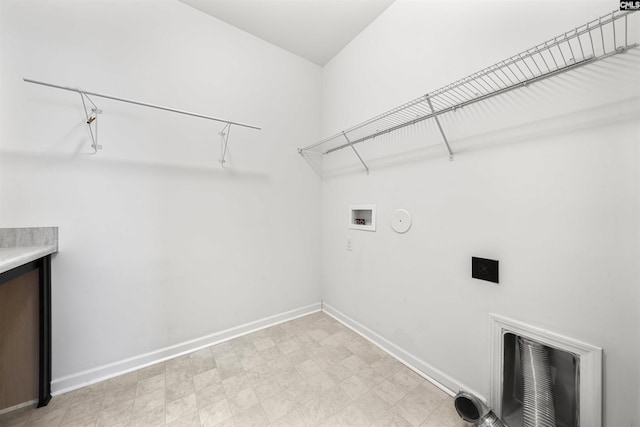 clothes washing area featuring hookup for a washing machine, laundry area, baseboards, and light floors