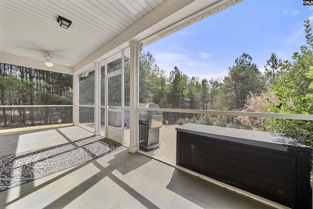 unfurnished sunroom with a ceiling fan