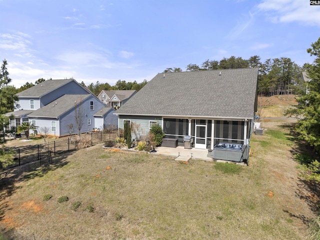 back of house featuring a sunroom, fence, a lawn, and roof with shingles