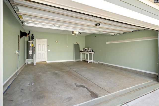 garage with a garage door opener, water heater, and baseboards