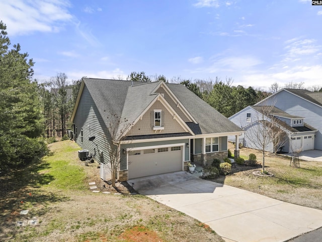 view of front of home with stone siding, cooling unit, concrete driveway, and roof with shingles