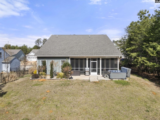 back of house with fence, a sunroom, a yard, roof with shingles, and a patio area