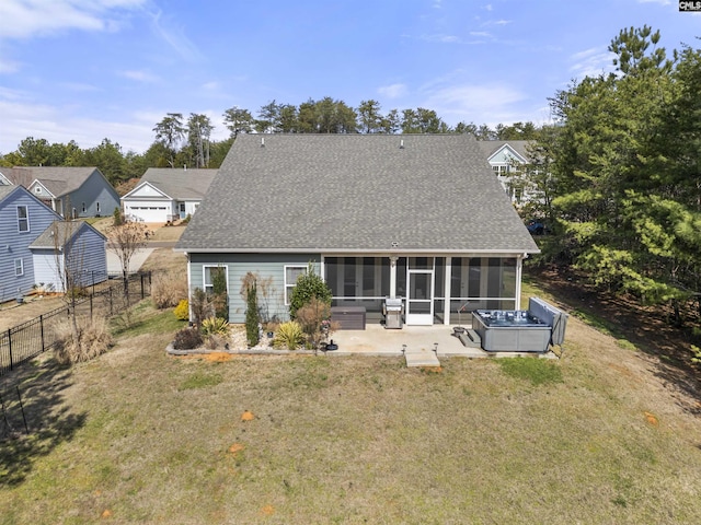 rear view of property featuring a sunroom, a yard, fence, and a patio