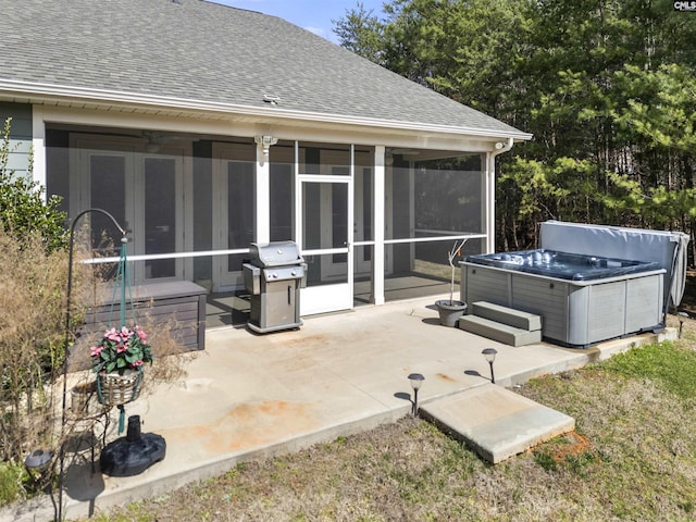 view of patio featuring a sunroom, a hot tub, and grilling area