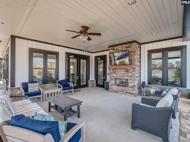 view of patio / terrace with a ceiling fan, french doors, and an outdoor living space with a fireplace