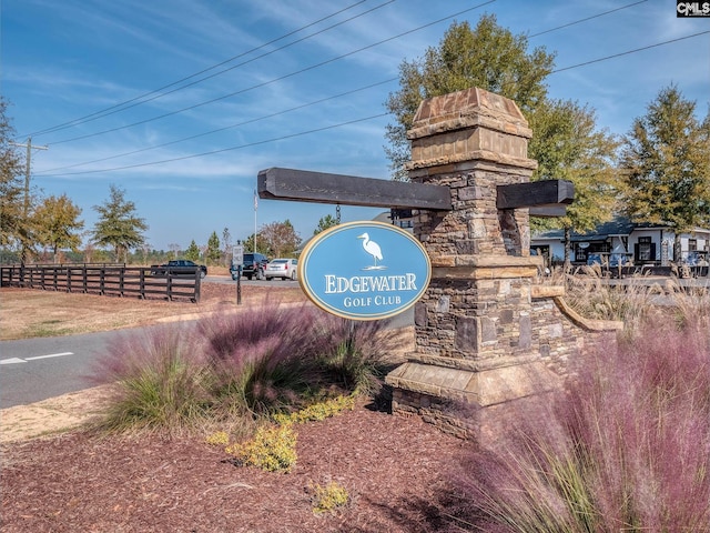 community / neighborhood sign with fence