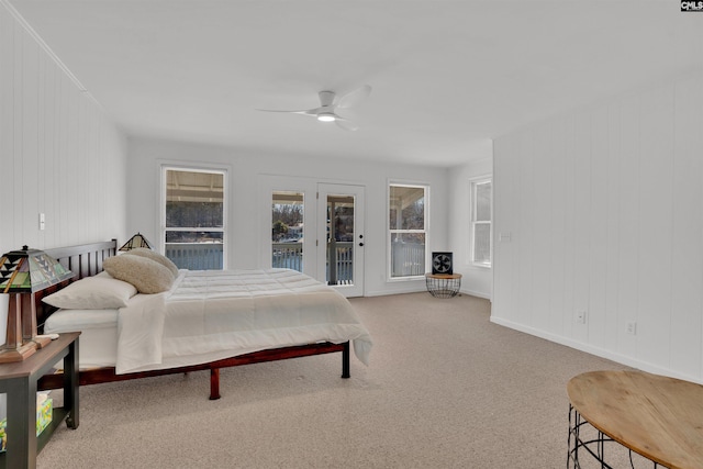 carpeted bedroom with baseboards, a ceiling fan, and access to exterior