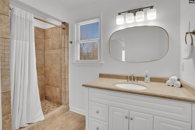 full bathroom featuring a stall shower, tile patterned flooring, and vanity