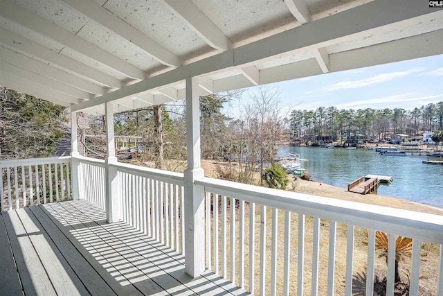 wooden deck featuring a boat dock and a water view