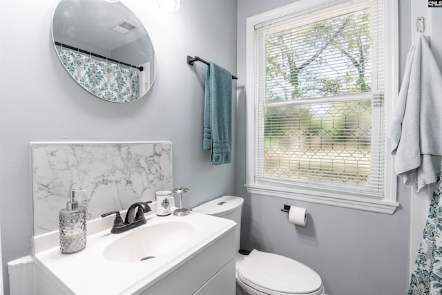 bathroom featuring toilet and vanity