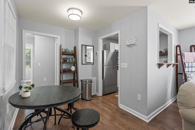 dining room featuring baseboards and dark wood finished floors