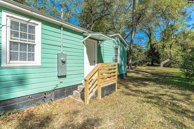 view of side of home featuring a lawn