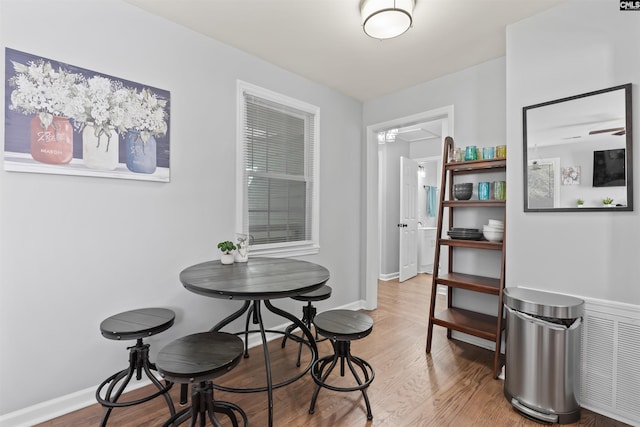 dining area featuring baseboards and wood finished floors