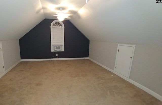 bonus room with light colored carpet, vaulted ceiling, baseboards, and ceiling fan