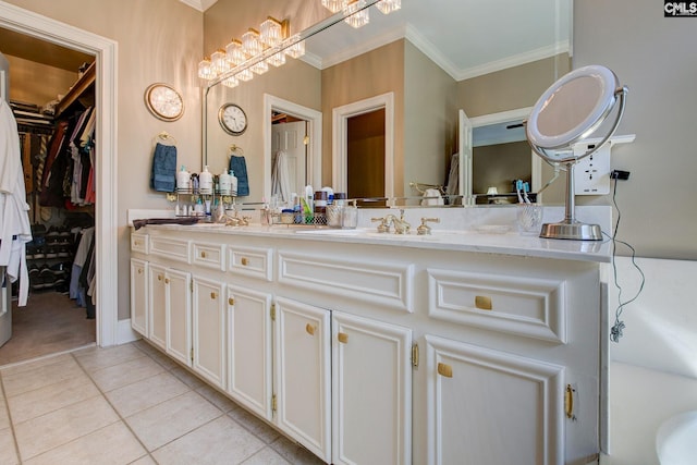 bathroom with double vanity, ornamental molding, tile patterned flooring, and a sink