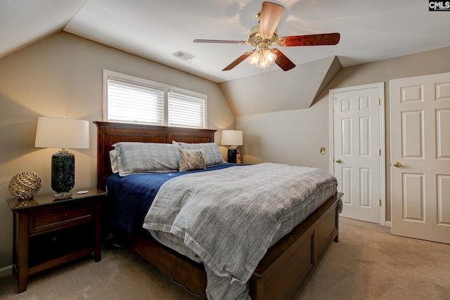 bedroom with a ceiling fan, visible vents, vaulted ceiling, and light carpet