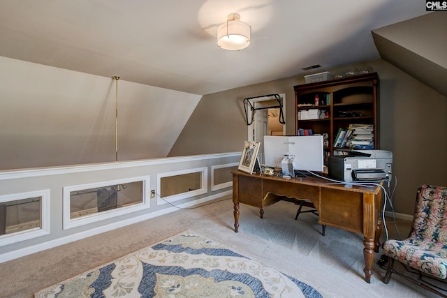 home office with carpet, visible vents, and vaulted ceiling