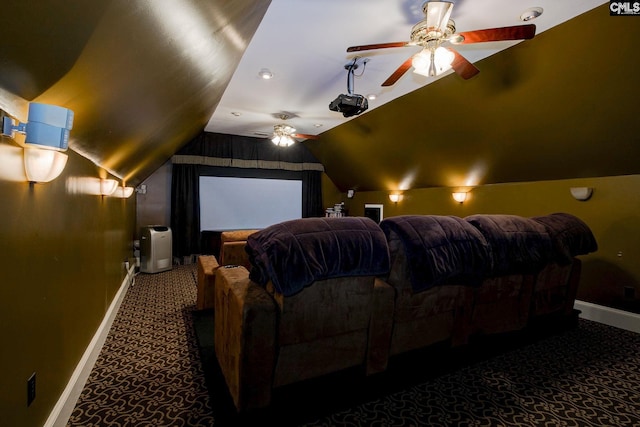 home theater room with lofted ceiling, carpet flooring, a ceiling fan, and baseboards