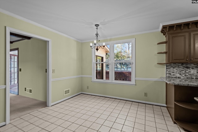 unfurnished dining area featuring light tile patterned floors, visible vents, and crown molding