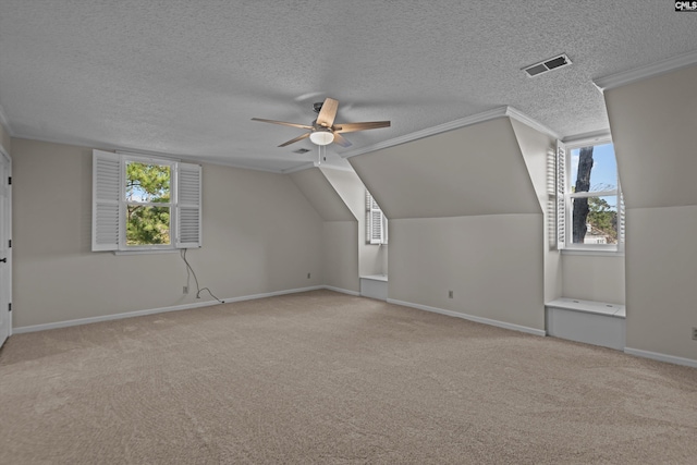 additional living space with baseboards, a ceiling fan, visible vents, and light colored carpet