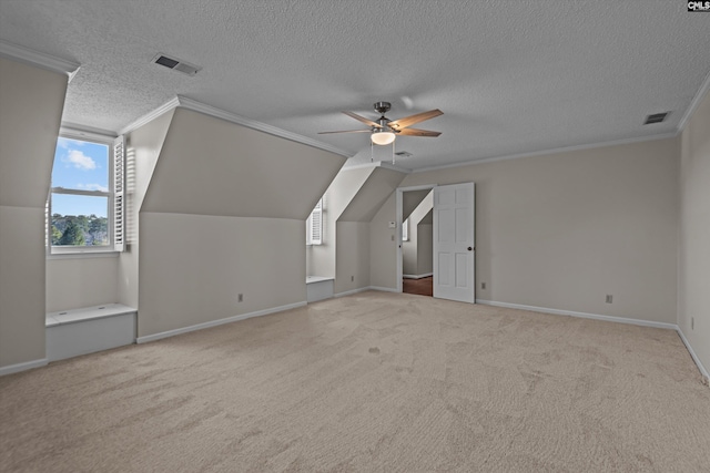 additional living space featuring carpet floors, visible vents, and ceiling fan