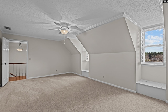 additional living space featuring a textured ceiling, carpet, lofted ceiling, and visible vents