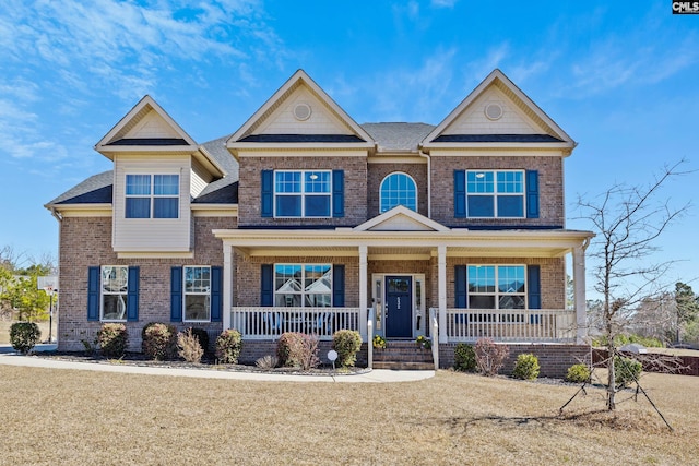 craftsman house with covered porch and brick siding