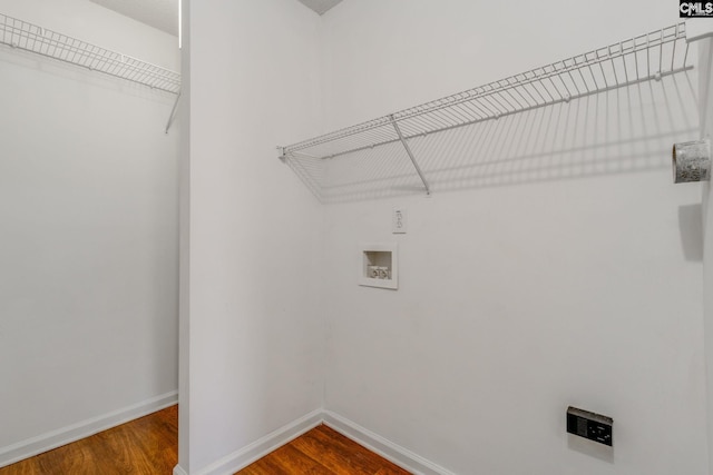 laundry area with laundry area, baseboards, washer hookup, and wood finished floors