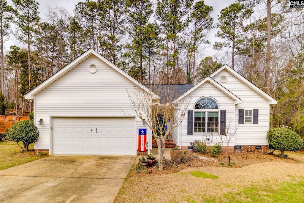 single story home featuring a front yard, crawl space, driveway, and an attached garage