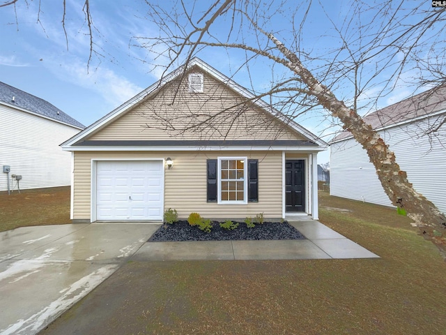 view of front of property featuring a front yard, concrete driveway, and an attached garage