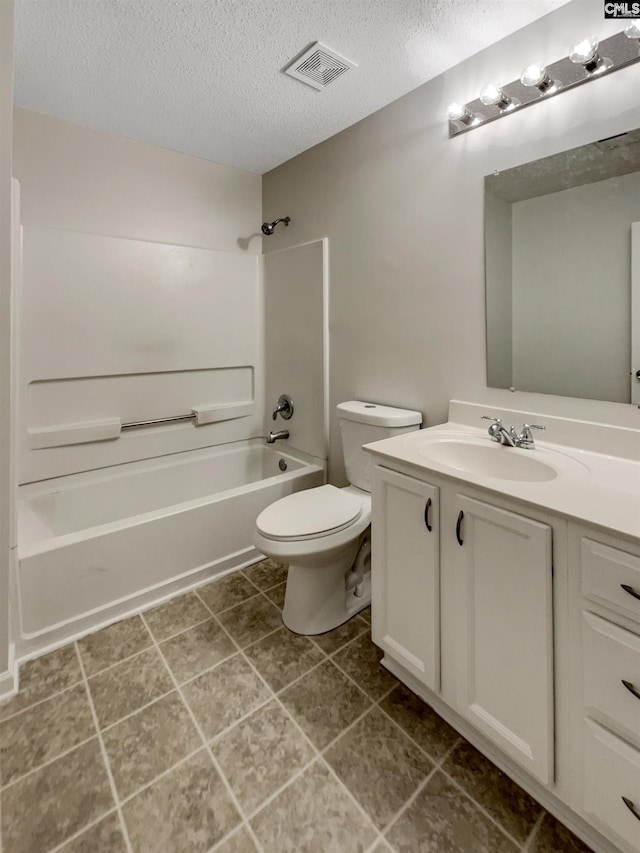 bathroom with a textured ceiling, toilet, vanity, visible vents, and shower / bathing tub combination