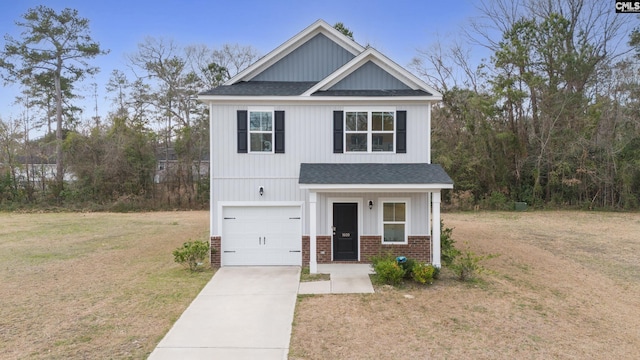 view of front of home featuring brick siding, a shingled roof, a front yard, a garage, and driveway