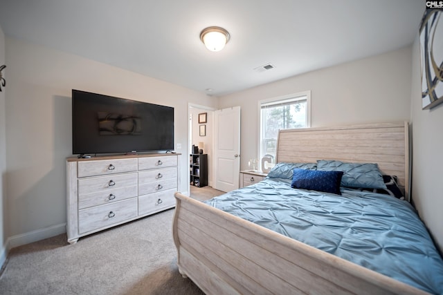 carpeted bedroom with baseboards and visible vents