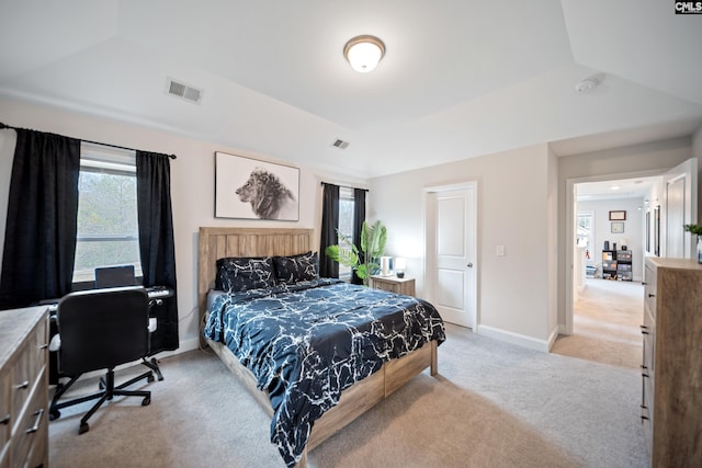 bedroom with light carpet, a raised ceiling, visible vents, and baseboards