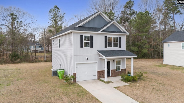 view of front of property with brick siding, a shingled roof, concrete driveway, and a front yard