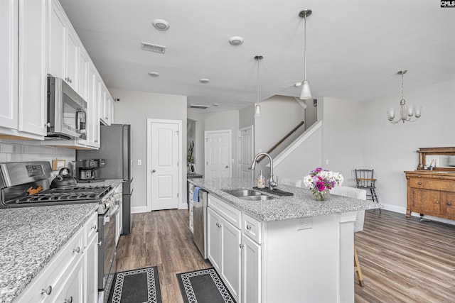 kitchen featuring stainless steel appliances, white cabinets, and a sink