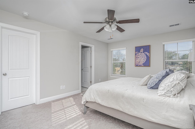 bedroom featuring baseboards, multiple windows, visible vents, and carpet flooring