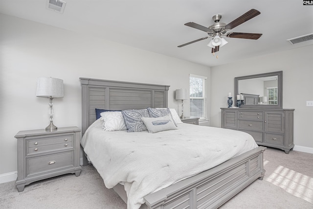 bedroom featuring light carpet, baseboards, visible vents, and a ceiling fan