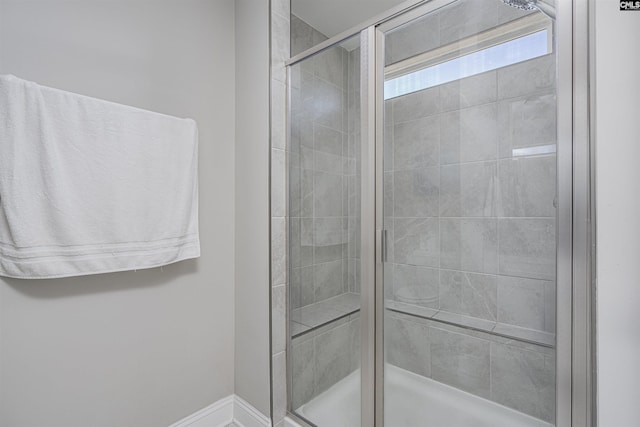 bathroom featuring a stall shower and baseboards