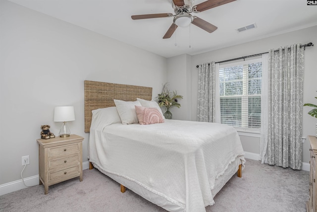 bedroom featuring light colored carpet, visible vents, and baseboards