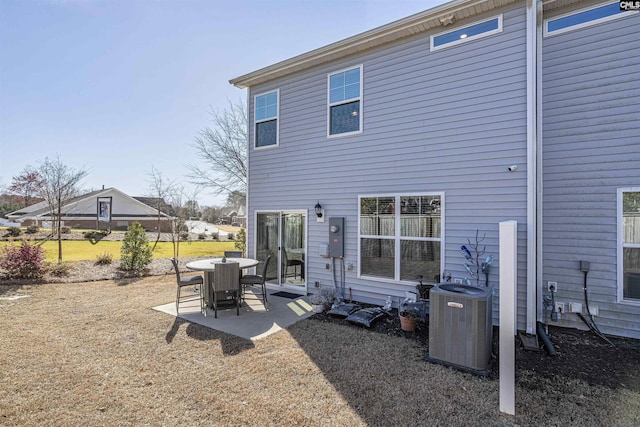 rear view of property with a patio area and central air condition unit