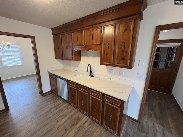 kitchen with dark wood-style floors, a sink, a textured ceiling, and stainless steel dishwasher