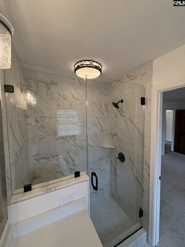 bathroom with a marble finish shower