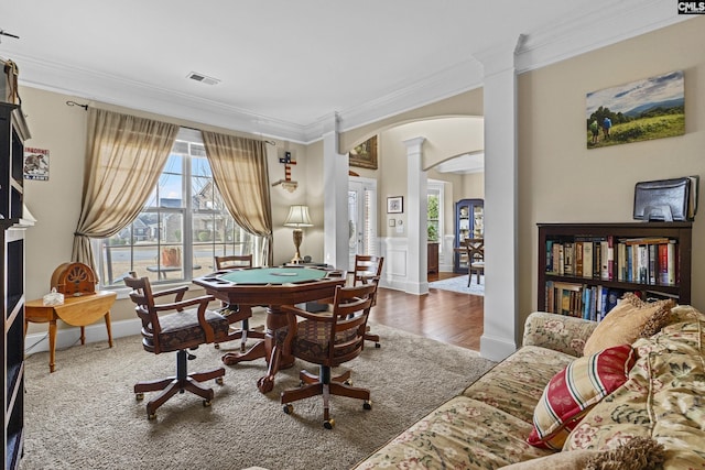 dining space with decorative columns, visible vents, arched walkways, and ornamental molding