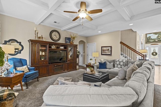 carpeted living area featuring arched walkways, beamed ceiling, stairway, and coffered ceiling