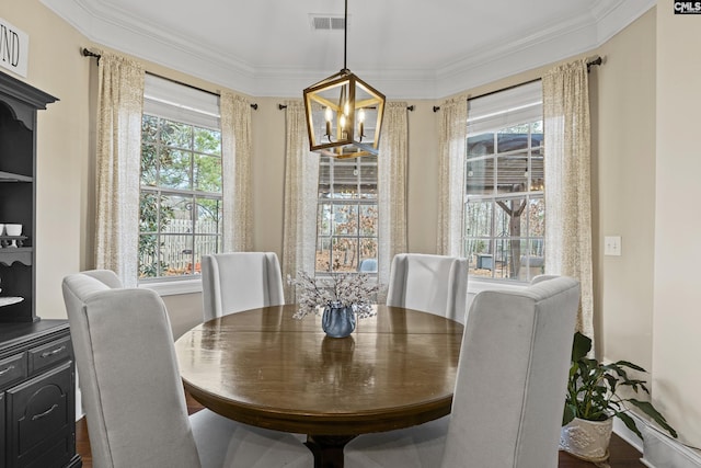 dining room featuring ornamental molding, visible vents, and a notable chandelier