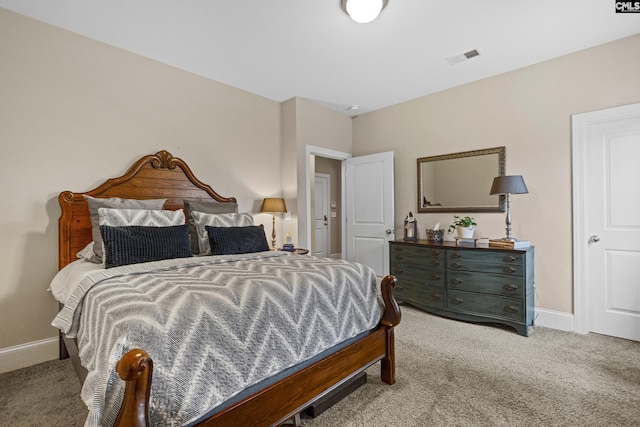 bedroom featuring light carpet, visible vents, and baseboards