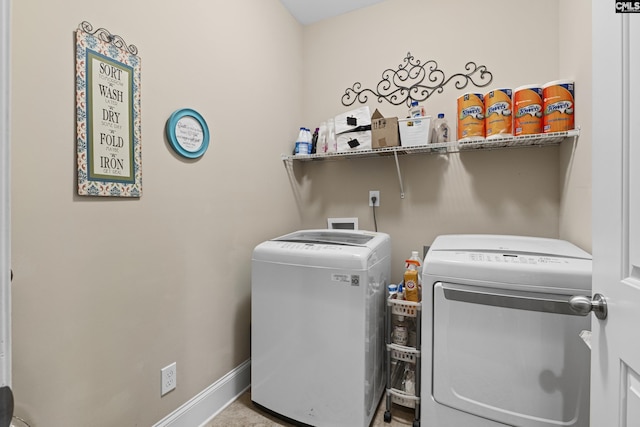 laundry area featuring washing machine and dryer, laundry area, and baseboards