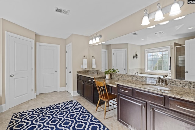 bathroom featuring tile patterned flooring, a sink, visible vents, double vanity, and a stall shower