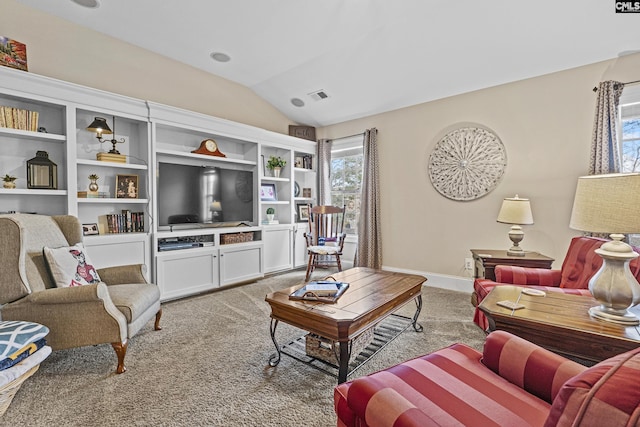 living area featuring light carpet, vaulted ceiling, visible vents, and baseboards